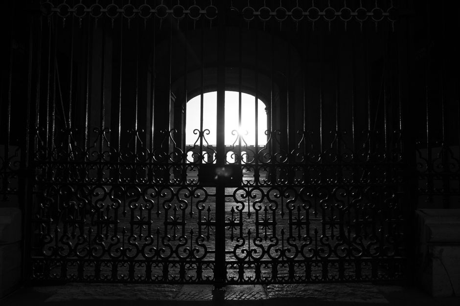 A painted iron gate closed across an entrance