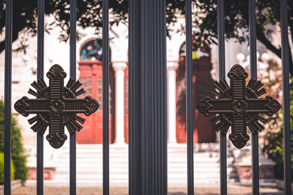 A close view of the bars and frame of a metal gate