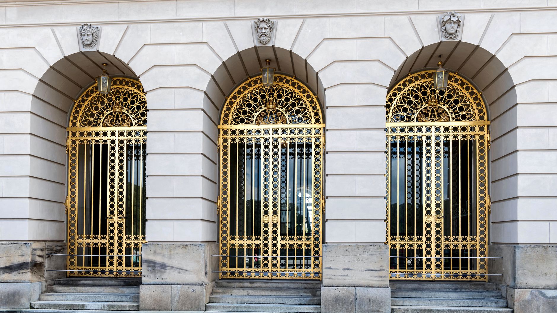Ornate golden metal gates and architectural details