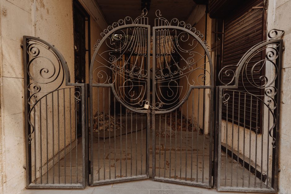 A close view of the bars and frame of a metal gate